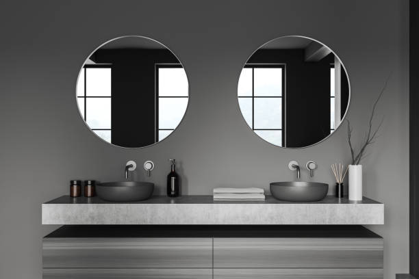 istock Grey bathroom interior with double sink and mirror, accessories on deck 1479311381