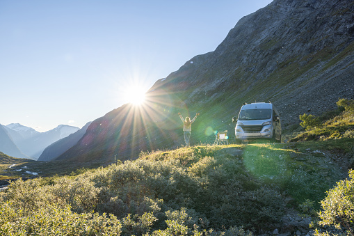 People travel, alternative homes concept. She looks at the beauty in nature. Sunset time on top of mountain pass