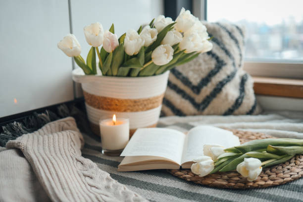 istock Open book, candle and basket with tulips, spring cozy composition in home interior 1479311717