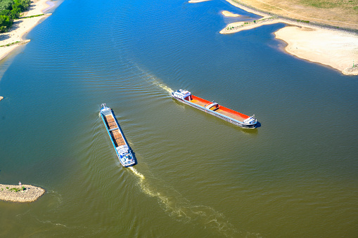 Ships passing Düsseldorf on the river Rhine with an exceptional low water level during a long period of drought in the summer of 2022.