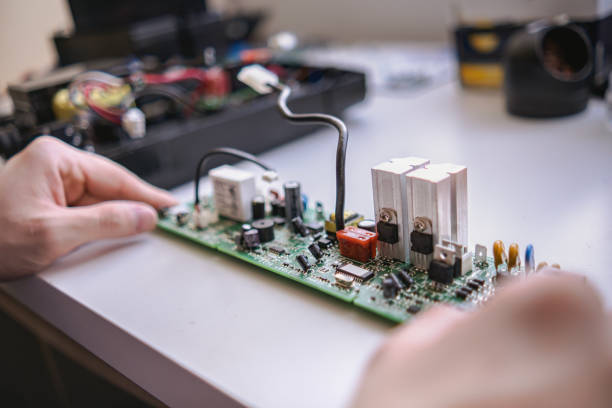 istock Inspecting a circuit board of an old apparatus 1479312236