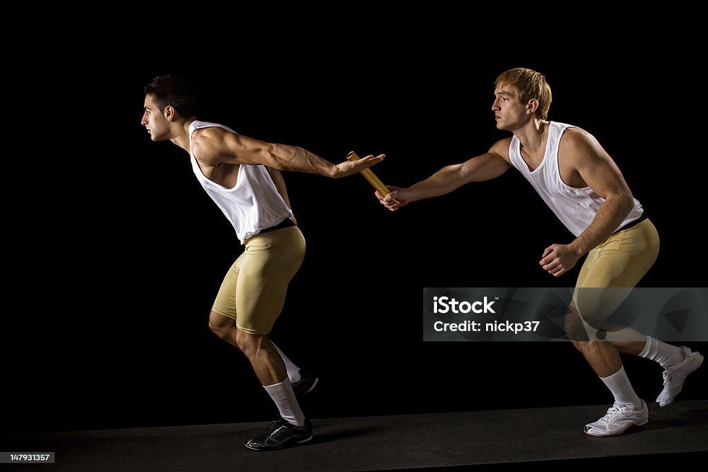 Two men running while the other passes a baton  Passing the Baton Relay Stock Photo