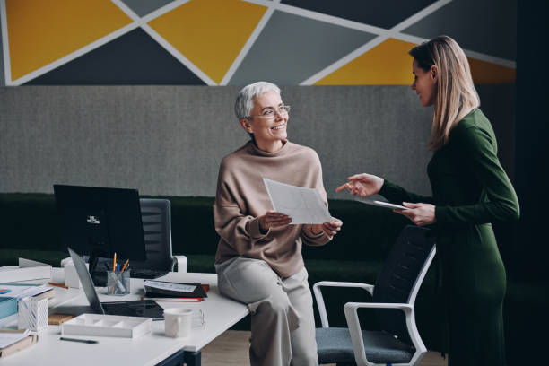 istock Two happy women discussing business while working in office together 1479314251