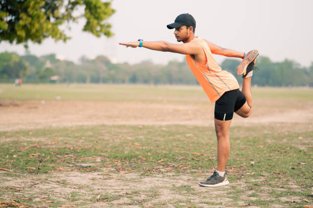 istock Young man doing lord of dance pose or stretching his body while doing morning exercise 1479314360