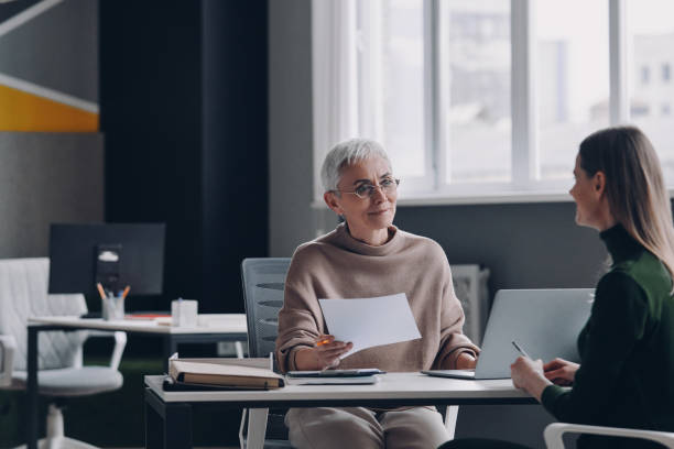 istock Senior female HR manager having interview with job candidate while sitting at the office desk 1479314402