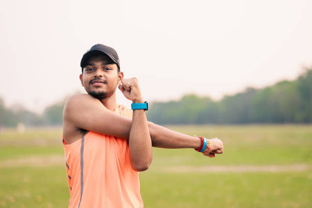 istock Shot of a sporty man starting his exercise routine with stretching exercises 1479314492