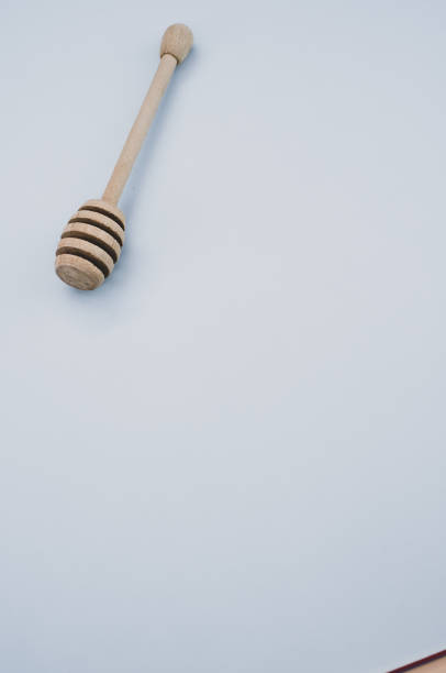 istock Vertical shot of a wooden honey dipper on a grey surface 1479315090