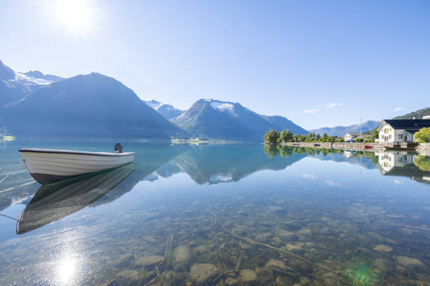 istock Boat floating on alpine lake in Norway, reflection on water surface 1479315134