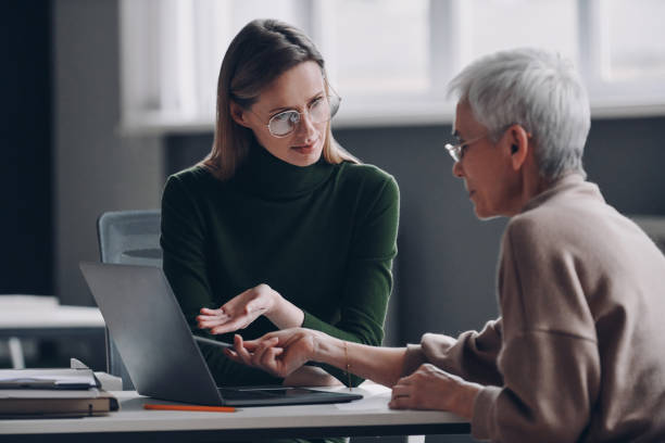 istock Confident financial advisor pointing laptop while discussing options with senior woman in office 1479315314