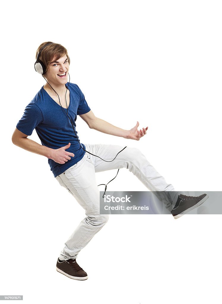 Dancing while listen music Portrait of a handsome young man dancing and listening music, isolated on white background Teenager Stock Photo