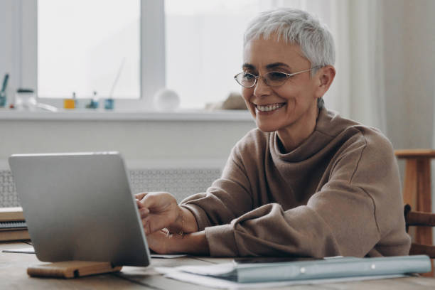 istock Happy senior businesswoman using digital tablet while sitting at her working place 1479316572