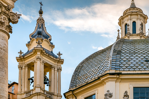 The beautiful Baroque style dome and bell tower of the church of Santa Maria dei Miracoli in Piazza del Popolo, between Via di Ripetta and Via del Corso, in the Piazza di Spagna district, in the historic heart of Rome. The church of Santa Maria dei Miracoli was built in Baroque style in 1675 by the architect Carlo Rainaldi at the request of Pope Alexander VII. In 1980 the historic center of Rome was declared a World Heritage Site by Unesco. Image in high definition format.