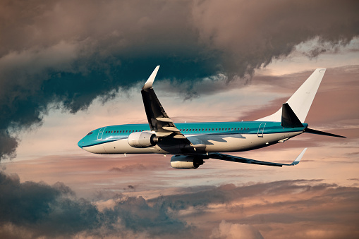 Passenger airplane departing at sunset