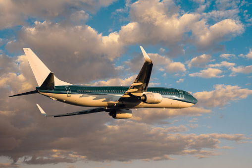 Passenger airplane departing at sunset