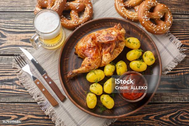 オクトーバーフェストフェスティバルの食べ物の半分のフライドチキンとゆでポテトソースビールプレッツェルのクローズアップ水平平面図 - バーベキューチキンのストックフォトや画像を多数ご用意