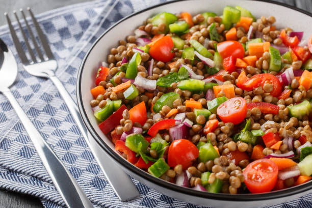 istock Fresh lentil salad with summer vegetables close-up in a plate. Horizontal 1479319787