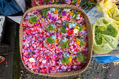 A basket full of flower petals at the market in Bali to be used for offerings, horizontal