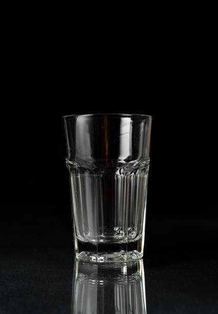 istock Empty glass on black background. Empty thick glass tumbler on dark background 1479321841