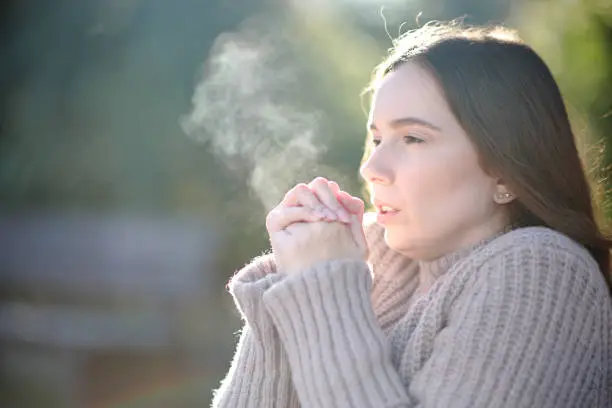 Woman breathing getting cold in winter