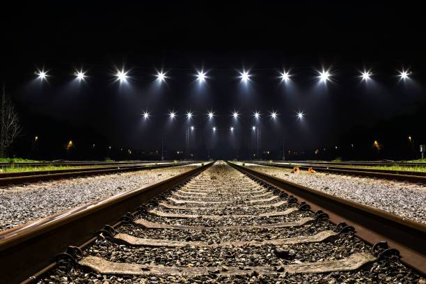 istock Dramatic nighttime landscape featuring a set of illuminated railway tracks 1479325499