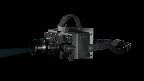 istock Large professional video camera with a bright light glinting off its lens on a black background 1479325561