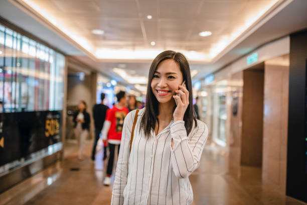 istock Asian Mature Woman Using Smart Phone In A Shopping Centre 1479325607