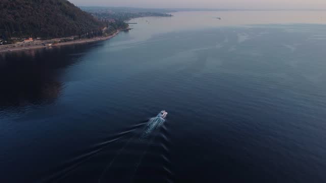 Drone footage of a boat on the Garda Lake in North Italy during sunset time