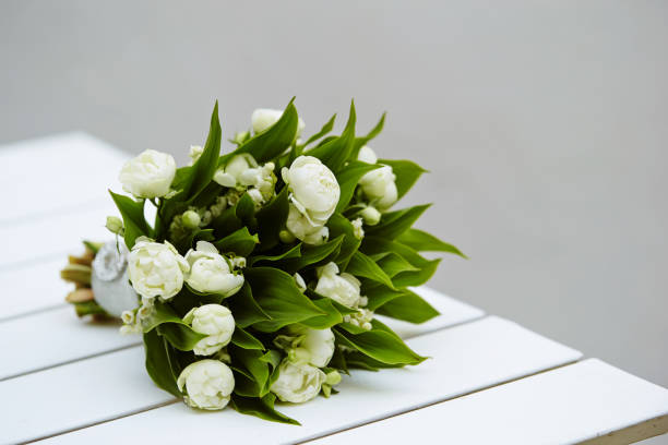 istock Closeup of beautiful white tulips bouquet on a white table 1479327614