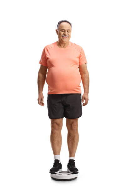 istock Corpulent mature man standing on a weight scale 1479327863