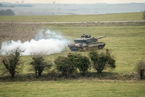 army main battle tank crossing countryside