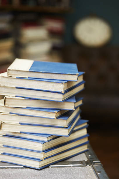 istock Vertical shot of a stack of books with white and blue covers 1479328607