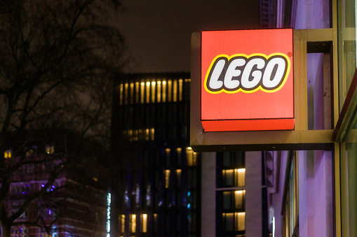 London, UK - 29 March, 2023: exterior architecture of a Lego store illuminated at night in central London, UK.