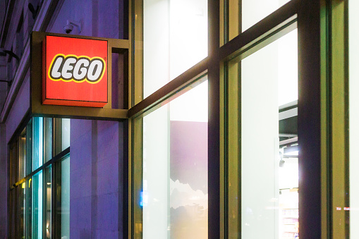 London, UK - 29 March, 2023: exterior architecture of a Lego store illuminated at night in central London, UK.