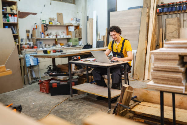 istock Craftsman working on administration paperwork at the woodshop 1479332372
