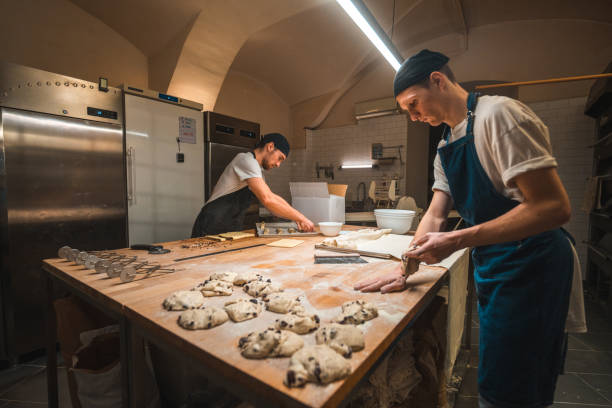 istock Caucasian Artisan Bakers Shaping Pastries In A Small Bakery 1479332437
