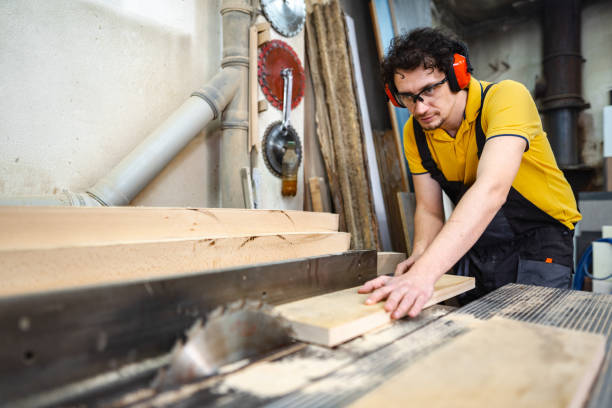 istock Carpenter using circular saw on a piece of wood in workshop 1479332569
