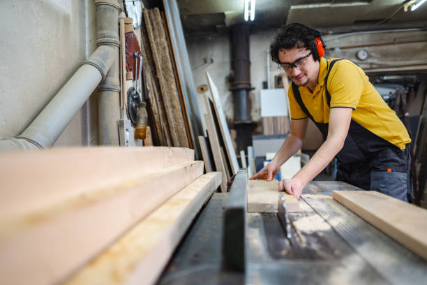 istock Carpenter using circular saw on a piece of wood in workshop 1479332698