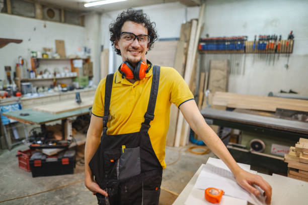 istock Portrait of a smiling carpenter with protective clothing in the workshop 1479332811