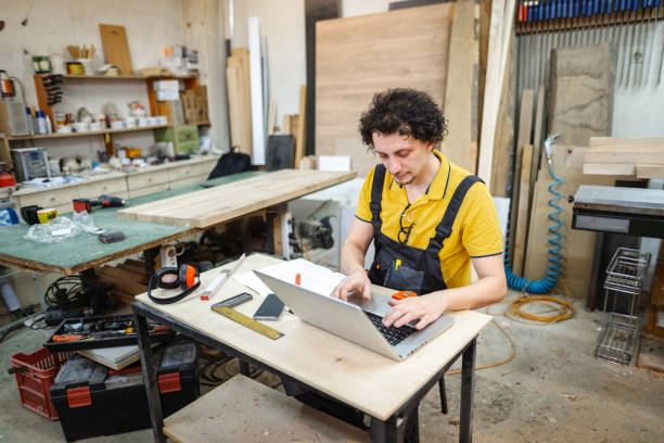 istock Craftsman working on paperwork at the woodshop 1479332823