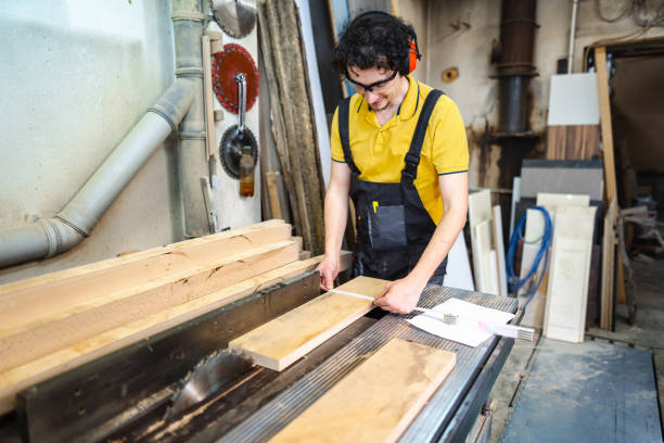 istock Carpenter using circular saw on a piece of wood in workshop 1479332826
