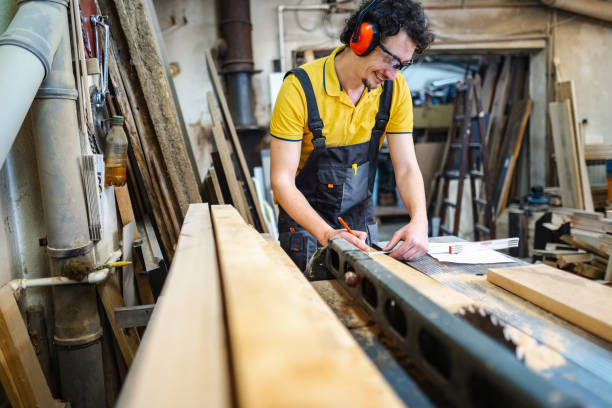 istock Carpenter using circular saw on a piece of wood in workshop 1479332831