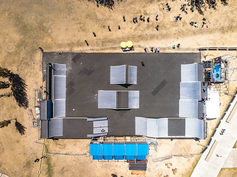 Aerial view of a skate park featuring ramps, rails, and half-pipes for skateboarders to enjoy