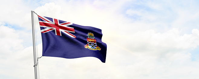 Cayman Islands flag waving on sky background. 3D Rendering