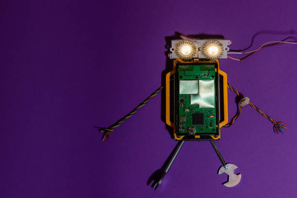 istock Hand made robot flat lay on the Open-sourced platform. DIY. AI. STEAM.purple dark background.Stem education for children and teenagers, robotics and electronics.Copy space. 1479336888