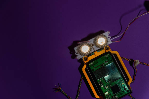 istock Hand made robot flat lay on the Open-sourced platform. DIY. AI. STEAM.purple dark background.Stem education for children and teenagers, robotics and electronics.Copy space. 1479336996