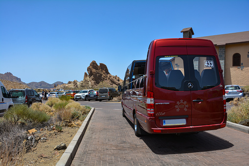Teide National Park, Tenerife, Spain August 13th, 2022 - Parking lot with open panoramic bus at the Parador de Cañadas del Teide excursion restaurant and hotel at Roques de García in the national park on the Canary island of Tenerife
