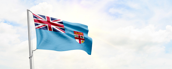Fiji flag waving on sky background. 3D Rendering