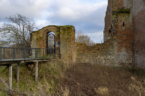Access bridge and part of remaining wall and tower of Nijenbeek castle in The Netherlands along the river IJssel