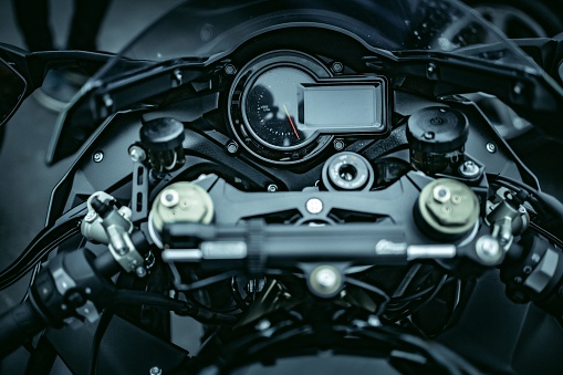 A closeup of the dashboard and speedometer of a modern motorcycle