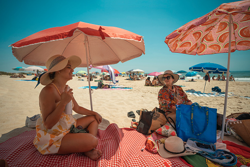 Tourists enjoying the beach under the beach umbrella